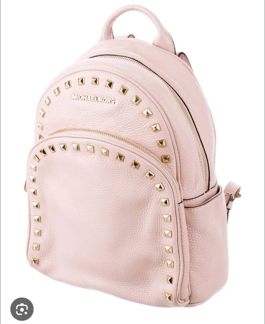 Michael Kors Abbey light pink backpack (Category: Backpacks) located in Tuguegarao City. Submitted by bili_naph (Listing ID 1460525332, Image 1). Description: ☆ Michael Kors Abbey light pink ☆ Studded pebbled leather backpack ☆ Featuring distinctive gold-tone pyramid hardware along the front and trim ☆ Medium size ☆ With adjustable straps ☆ Normal sign of use ☆ No major flaw ☆ BN retails for P18k to P26k ☆ Steal at P1,650.00.