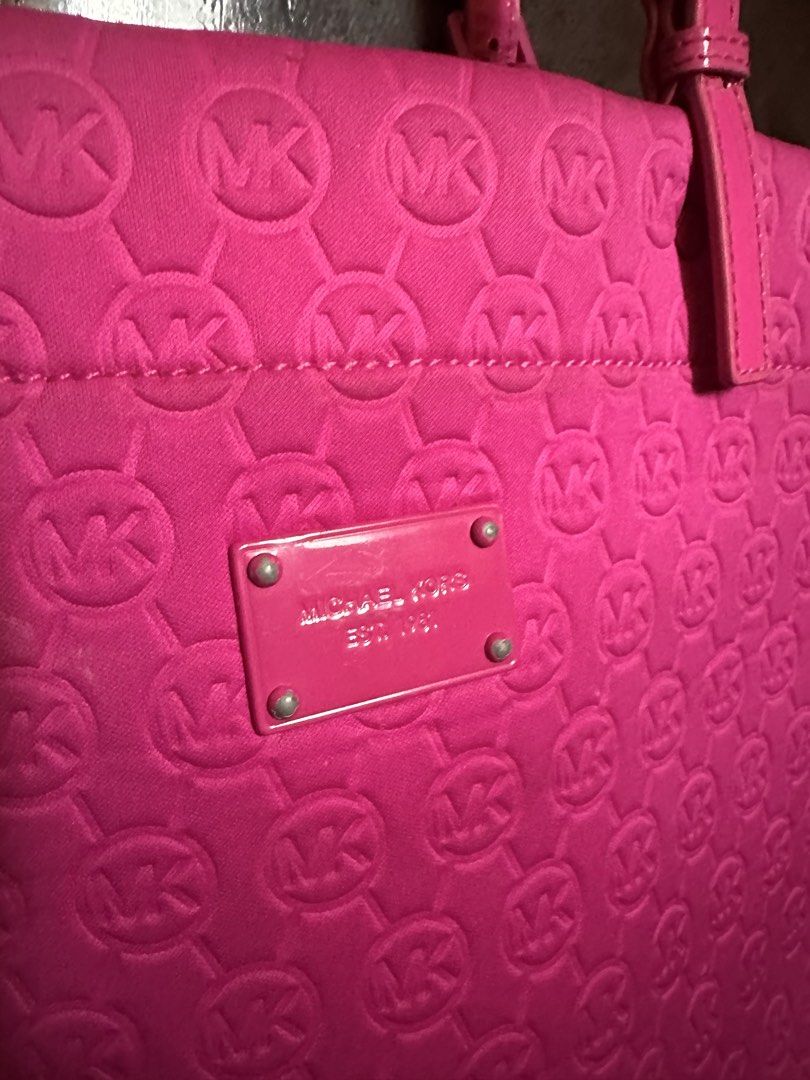 Michael Kors Pink Monogram Tote Bag (Category: Luxury Bags & Wallets) located in Makati City. Submitted by msjlarsen (Listing ID 1460531357, Image 2). Description: - Bright pink Michael Kors tote bag - All-over MK monogram pattern - Patent leather straps and trim - Silver tone hardware with Michael Kors logo plate - Ideal for everyday use or travel - see last photo to see issue of the bag.
