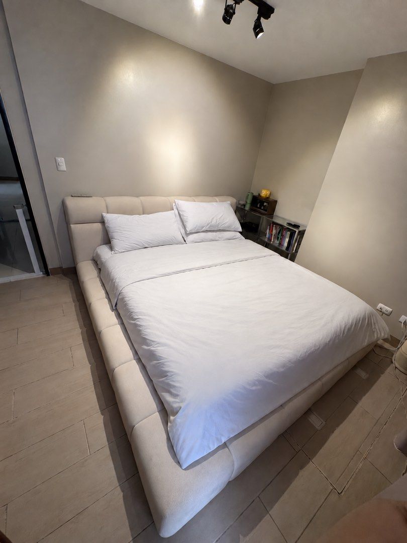 Modern Upholstered Platform Bed Frame with Headboard (Category: Bed Frames & Mattresses) located in Quezon City. Submitted by rehms (Listing ID 1460681628, Image 1). Description: Barely Used Custom-Made King-Size Upholstered Bed Frame - Custom-made by Bedworks PH - Bought for ₱45,000, Used for 1 year only. - King size: 72” × 78” - Made with kiln-dried mahogany wood and marine plywood - Thick Uratex foam padding around the headboard, sides, and fo
