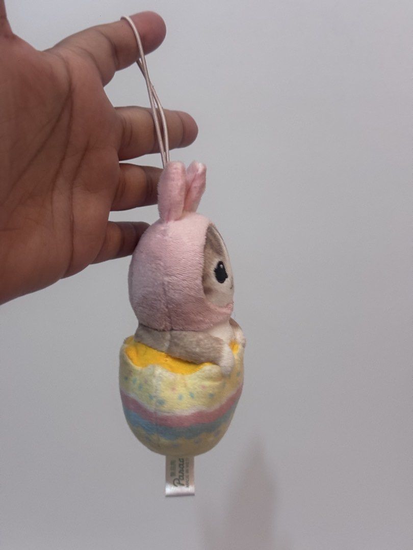 Mofusand Easter Nyan plush charm (Category: Plushies & Soft Toys) located in Antipolo. Submitted by bhabiegraciefashionlab (Listing ID 1460533224, Image 2). Description: mofusand Easter Nyan plush mascot by FuRyu, showing a small cat in a pink bunny hood inside a pastel egg. Product Details 🐱Character: mofusand cat 🐱Design: Cat wearing a pink rabbit hood 🐱Container: Colorful Easter egg base with a hanging strap 🐱Size: About 8 centimeters 🐱Ma