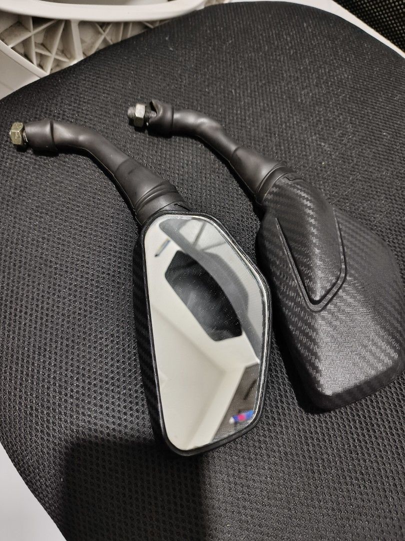 Motorcycle Side Mirrors with Carbon Fiber Look (Category: Other Motorcycles Parts and Accessories) located in Tuguegarao City. Submitted by domzaiii (Listing ID 1460647536, Image 1). Description: - Pair of motorcycle side mirrors - Black stems with carbon fiber pattern housing - Rectangular shape with rounded corners - Universal fit for most motorcycles - Mounting bolts included - Please check your bike's mounting size before purchasing.
