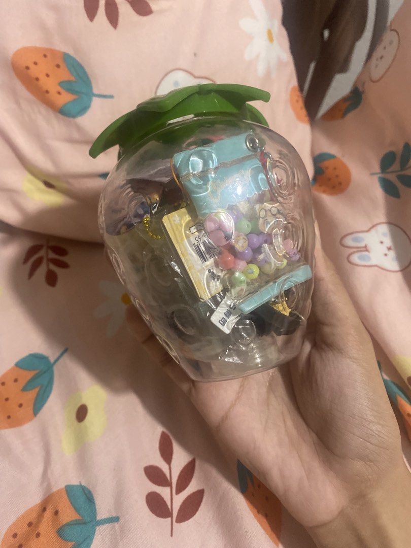 Mystery Trinket Jar! 🍓✨ (Category: Handmade Craft) located in Taguig. Submitted by declutterwkeish (Listing ID 1460681480, Image 3). Description: 🧚‍♀️ Inclusion: - Freebies - Strawberry Jar - Trinkets ₱250 ALL IN Mystery so expect na assorted yung trinkets. But all in great condition !.