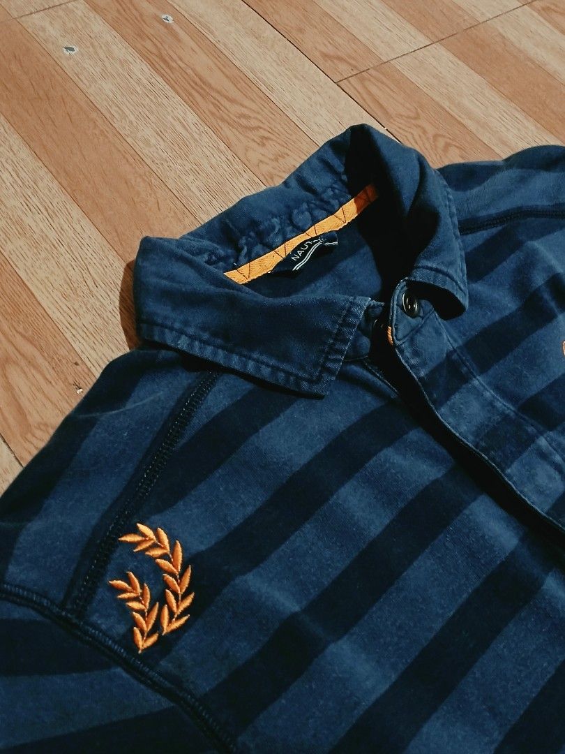 NAUTICA Blue Sail Polo (Category: Coats, Jackets and Outerwear) located in Cabuyao City. Submitted by lamperouge11 (Listing ID 1460642327, Image 3). Description: A piece of Button up polo from nautica in a blue colorway stripes. Features: - A button up mechanism. - A chest button pocket - An embroidery "Nautica Blue Sail" on top of the chest pocket. - An embroidery plant design on the left shoulder. Flaws: None other than cut wash tag. Condition:
