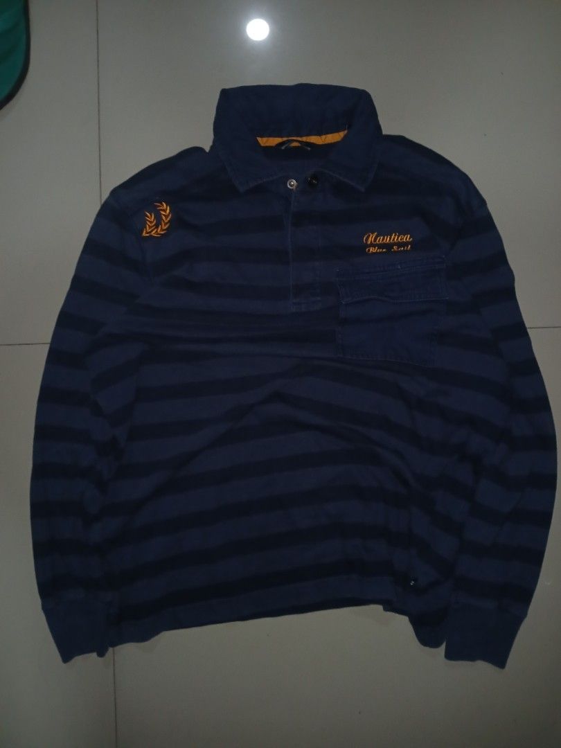 NAUTICA Blue Sail Polo (Category: Coats, Jackets and Outerwear) located in Cabuyao City. Submitted by lamperouge11 (Listing ID 1460642327, Image 1). Description: A piece of Button up polo from nautica in a blue colorway stripes. Features: - A button up mechanism. - A chest button pocket - An embroidery "Nautica Blue Sail" on top of the chest pocket. - An embroidery plant design on the left shoulder. Flaws: None other than cut wash tag. Condition: