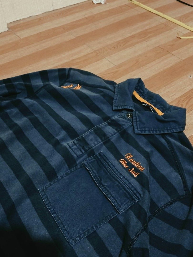 NAUTICA Blue Sail Polo (Category: Coats, Jackets and Outerwear) located in Cabuyao City. Submitted by lamperouge11 (Listing ID 1460642327, Image 2). Description: A piece of Button up polo from nautica in a blue colorway stripes. Features: - A button up mechanism. - A chest button pocket - An embroidery "Nautica Blue Sail" on top of the chest pocket. - An embroidery plant design on the left shoulder. Flaws: None other than cut wash tag. Condition: