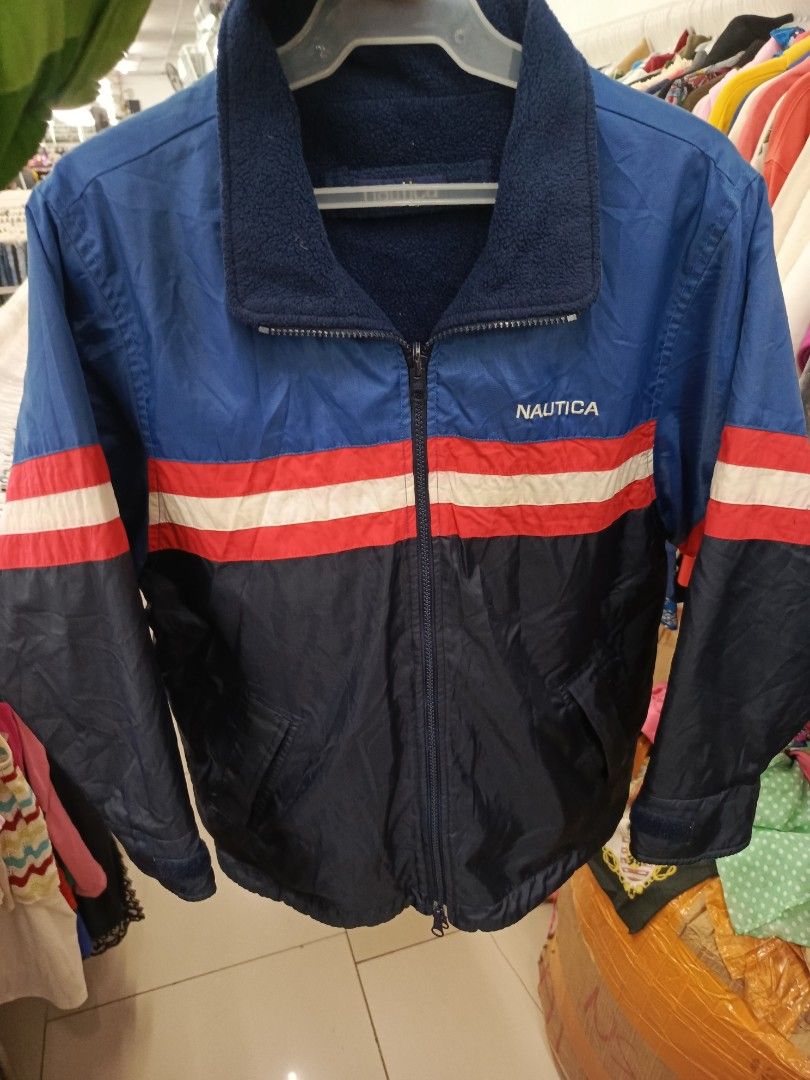 Nautica Reversible Fleece Lined Jacket (Category: Coats, Jackets and Outerwear) located in Cabatuan. Submitted by penthegreat (Listing ID 1460711108, Image 1). Description: - Classic Nautica jacket - Color: Blue with red and white stripes - Reversible design: One side is the classic blue, the other is a cozy fleece lining - Full zip closure - Two side pockets - Ideal for cooler weather and casual wear.