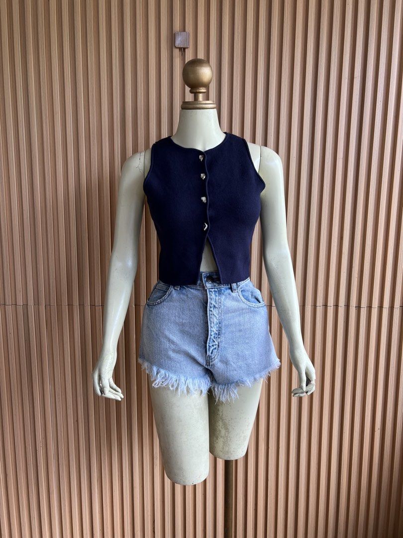 Navy Blue Sleeveless Button-Up Knit Crop Top (Category: Sleeveless) located in Lipa City. Submitted by thyra06 (Listing ID 1460585118, Image 3). Description: - Navy blue knit crop top - Sleeveless with round neckline - Silver button-down front detail - Cropped length (hits above waist) - Versatile for casual or dressy looks - Pairs well with high-waisted shorts or jeans.