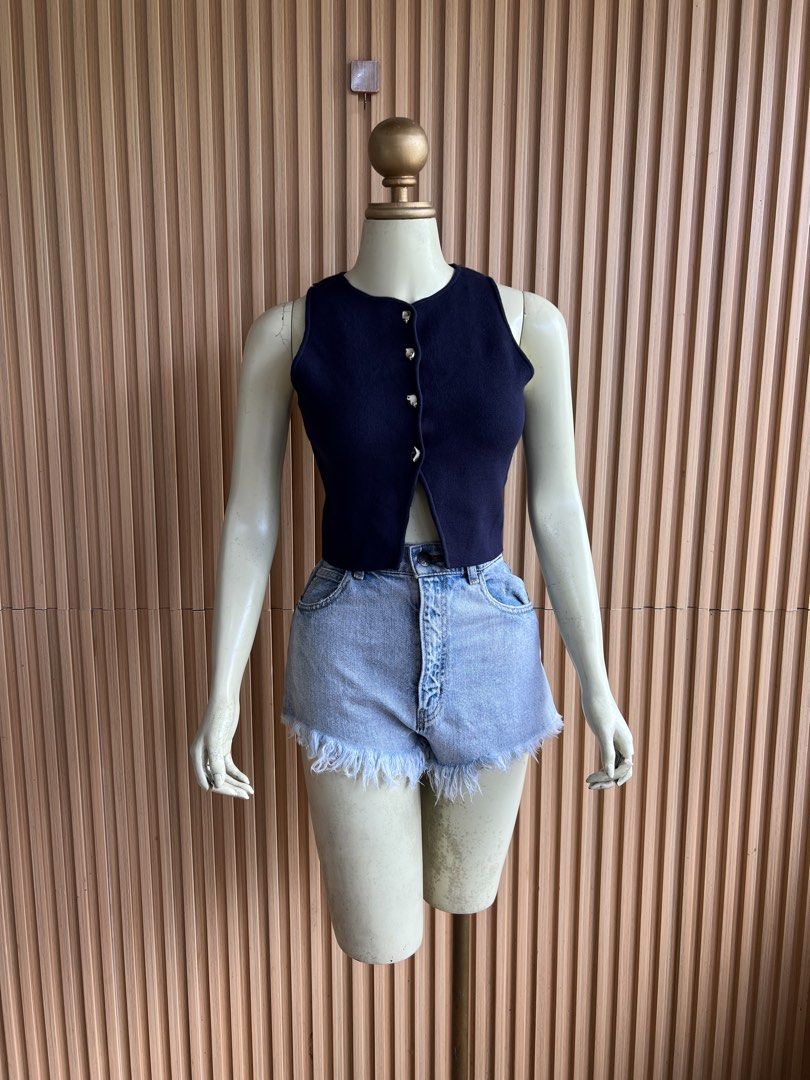 Navy Blue Sleeveless Button-Up Knit Crop Top (Category: Sleeveless) located in Lipa City. Submitted by thyra06 (Listing ID 1460585118, Image 1). Description: - Navy blue knit crop top - Sleeveless with round neckline - Silver button-down front detail - Cropped length (hits above waist) - Versatile for casual or dressy looks - Pairs well with high-waisted shorts or jeans.