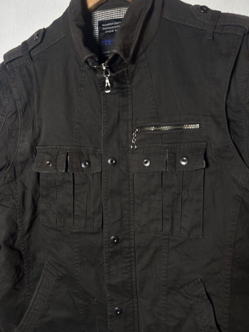 Nicole Club Men's Brown Utility Jacket (Category: Coats, Jackets and Outerwear) located in Tuguegarao City. Submitted by thrift_ni_boy (Listing ID 1460536724, Image 3). Description: - Brown utility jacket from Nicole Club - Features multiple front pockets, some with zippers - Button-up closure - Stand-up collar design - Versatile: can be worn as a vest - Ideal for casual wear.