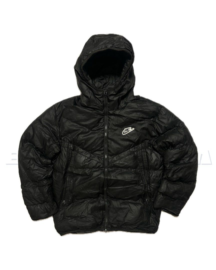 Nike Black Hooded Puffer Jacket (Category: Coats, Jackets and Outerwear) located in Santa Rosa. Submitted by vardo.blvnt (Listing ID 1460523670, Image 1). Description: - Black Nike puffer jacket - Attached hood for extra warmth - Iconic Nike swoosh logo on the chest - Full zipper closure - Two convenient zip pockets on the front - Ideal for cold weather.