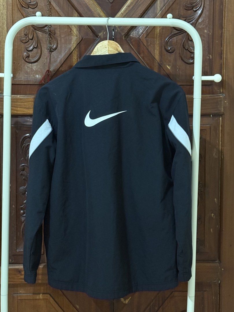 Nike Black Track Jacket with White Stripes XL (Category: Coats, Jackets and Outerwear) located in Iloilo. Submitted by wornwellco (Listing ID 1460550094, Image 3). Description: Black Nike track jacket. Features white stripe details across the chest and sleeves. Full zip closure. Size XL. Great for casual wear or sports..