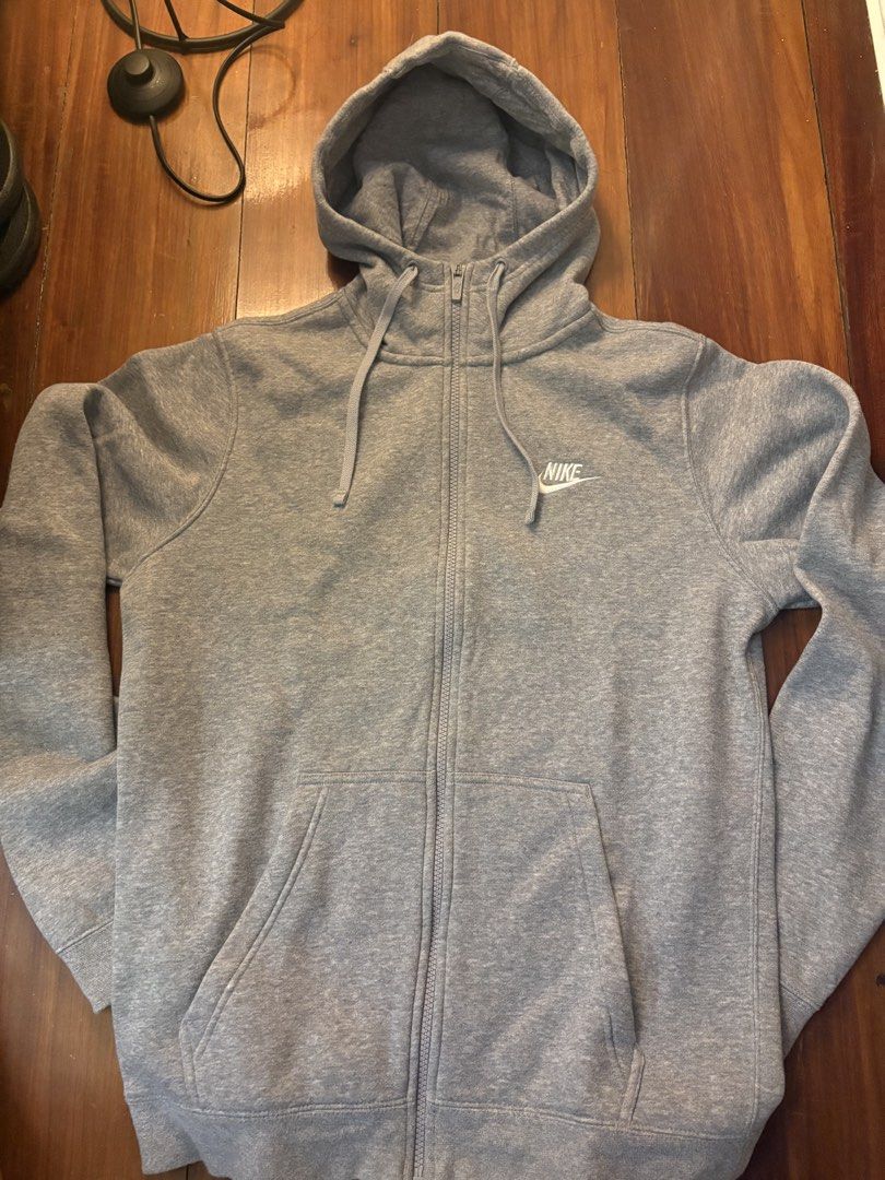 Nike Grey Zip-Up Hoodie (Category: Coats, Jackets and Outerwear) located in Paranaque City. Submitted by max_bully014 (Listing ID 1460592165, Image 1). Description: - Grey Nike zip-up hoodie - Classic Nike logo on chest - Adjustable drawstrings on hood - Two convenient front pockets - Comfortable and casual design - Ideal for everyday wear.
