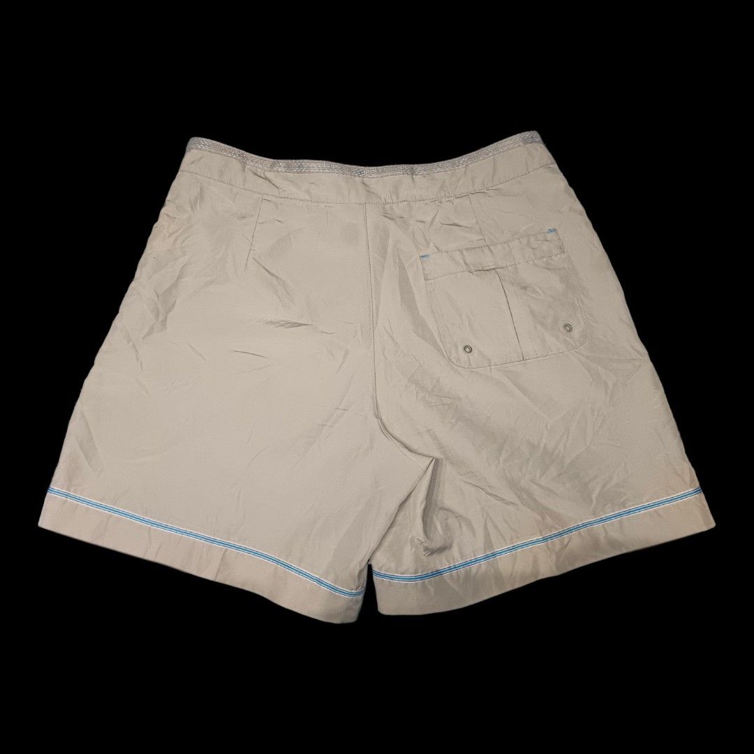 Nike shorts (Category: Shorts) located in Baguio. Submitted by evthrfts36211 (Listing ID 1460659390, Image 2). Description: Nike Beige Shorts Brand: Nike Color: Beige / Khaki Style: Athletic / Casual Shorts Classic Nike Swoosh logo on the leg Elastic waistband with adjustable drawstring Front button and zip closure Two side pockets Blue-and-white stripe detail along the bottom hem Lightweight woven fabric Relaxed, comfortable fit Great for casual
