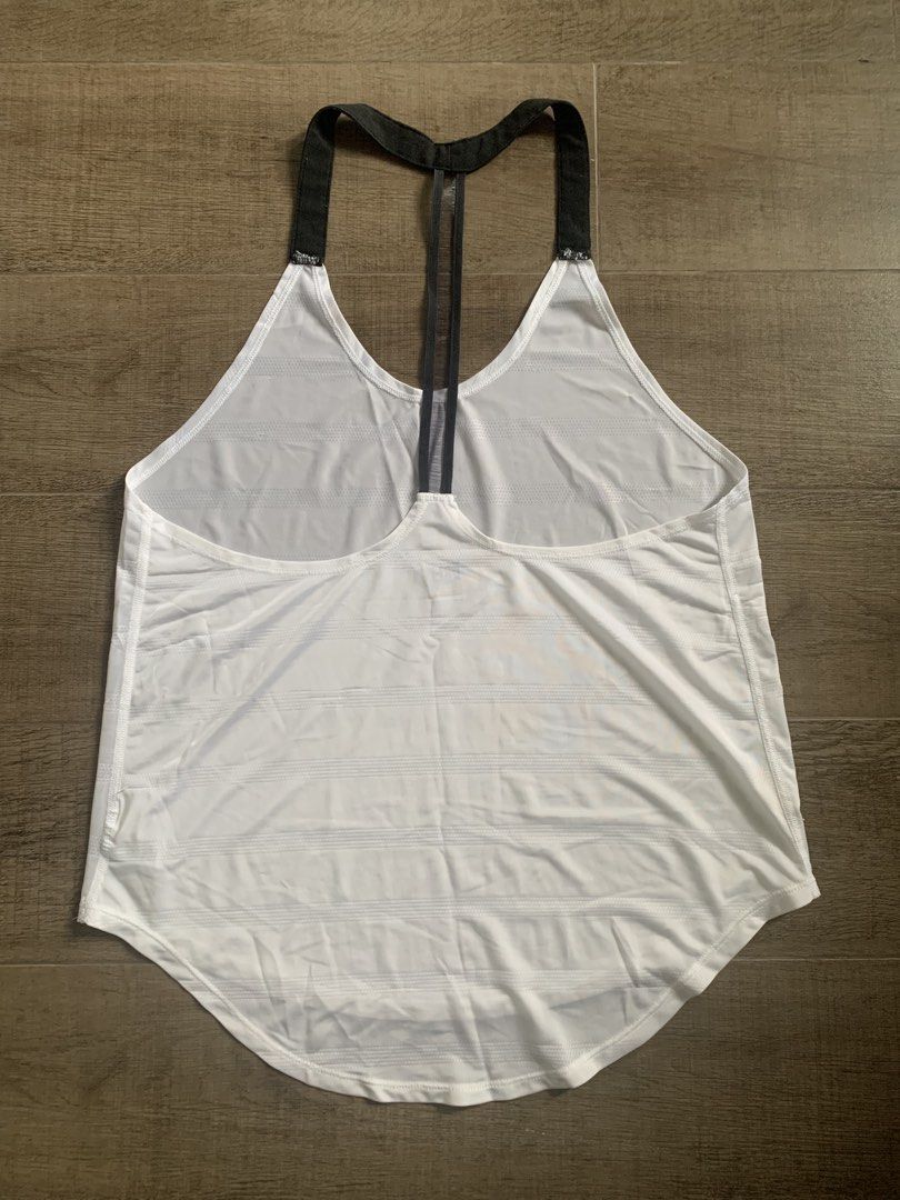 Nike White Athletic Tank Top (Category: Activewear) located in Taguig. Submitted by mrs.k.see (Listing ID 1460566341, Image 2). Description: - White Nike athletic tank top - Racerback style with mesh detailing - Lightweight and breathable fabric - Ideal for workouts or casual wear - Small Nike logo on the hem.