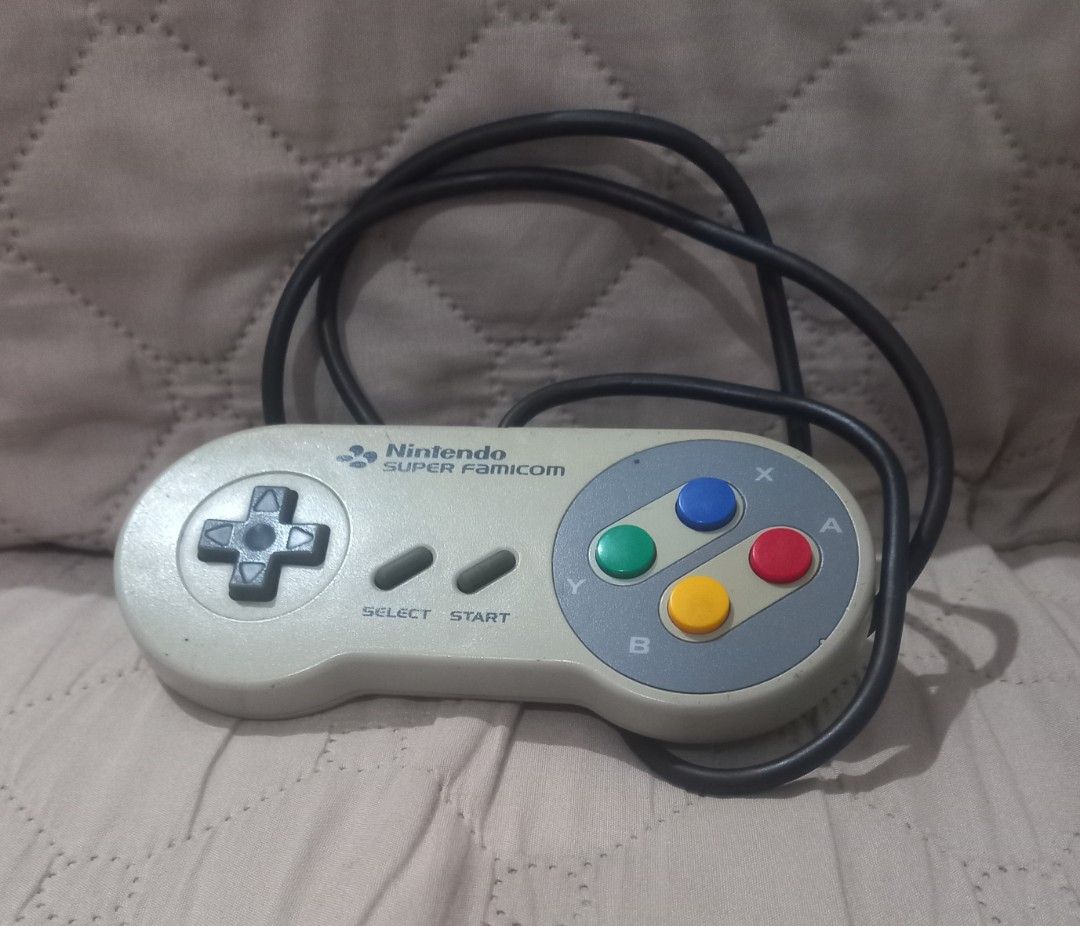 Nintendo Super Famicom Controller (Category: Controllers) located in Valenzuela. Submitted by retro.rush (Listing ID 1460619502, Image 1). Description: - Original Nintendo Super Famicom controller - Tested and works well - Shows minor signs of wear from normal use -discoloration & scratches - Ideal for collectors and retro gaming enthusiasts - Relive classic SNES/Super Famicom gaming experiences .
