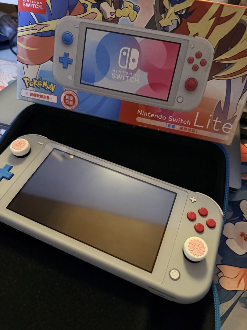 Nintendo Switch Lite Pokemon Edition Consol e (Category: Nintendo) located in Caloocan City. Submitted by lunalivie (Listing ID 1460520196, Image 3). Description: - Nintendo Switch Lite - Pokemon Zacian & Zamazenta Edition - Includes original box - Comes with a hori protective case (used) - Features cute pink thumb grips - 128gb sd card included.