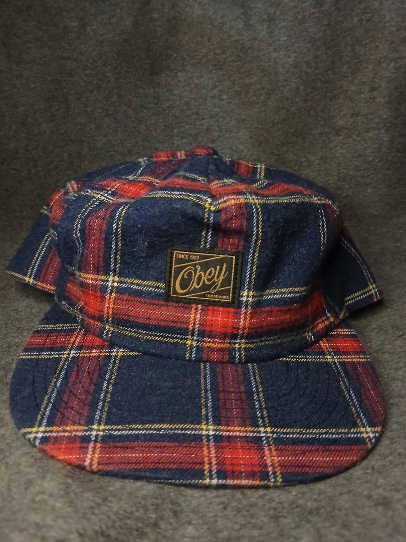 Obey Plaid 5-Panel Cap (Category: Caps & Hats) located in Caloocan City. Submitted by benthriftshp (Listing ID 1460681902, Image 1). Description: - Classic Obey cap with a timeless plaid pattern. - Features the iconic Obey logo tag prominently on the front. - Ideal for adding a touch of casual cool to any outfit. - Please refer to the provided photos for a closer look at the cap's details and condition. 8.9 colorate 400+sf.