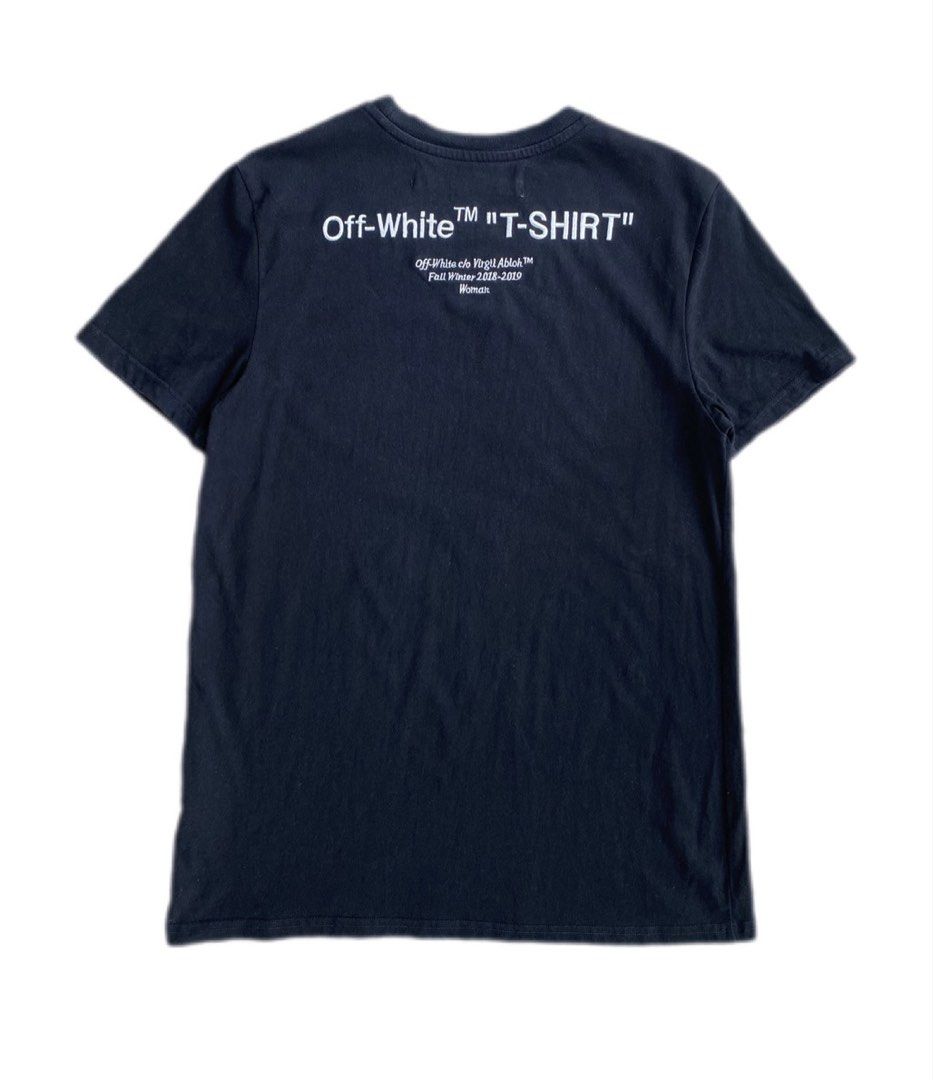OFF-WHITE "T-SHIRT" Black Tee FW 2018-2019 (Category: Tshirts & Polo Shirts ) located in Maria Aurora. Submitted by archives767 (Listing ID 1460652313, Image 2). Description: - Authentic Black Off-White "T-SHIRT" tee - Features the classic Off-White logo prominently on the front - Back design includes "T-SHIRT" text and "Off-White c/o Virgil Abloh™ Fall Winter 2018-2019" details - A must-have addition to any streetwear enthusiast's collection - P