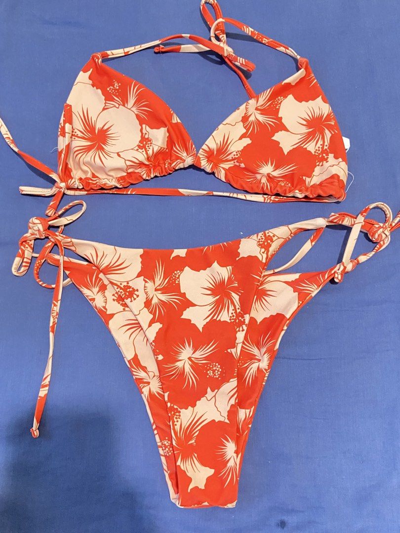 Orange Floral Bikini Set (Category: Bikinis & Swimsuits) located in Mandaluyong City. Submitted by coolmami (Listing ID 1460624956, Image 1). Description: - Adorable orange and white floral print bikini - Triangle top with adjustable tie straps - Matching bottoms with adjustable tie sides - Ideal for beach days or poolside lounging - Get ready for your next vacation!.
