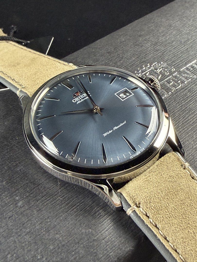 Orient Bambino Version 4 (Category: Men's Watches) located in Bacoor. Submitted by offtheclock (Listing ID 1460682446, Image 2). Description: Orient Bambino Version 4 Condition: Brandnew Reference No: RA-AC0P03L30B Movement: Automatic Self Winding (F6724) Power Reserve: 40 Hours Material: 316L Stainless Steel Case Diameter: 42mm (Domed Mineral Crystal) Dial: Deep Grey-Blue with Metallic Sunray Finish Strap: Original Tan Suede Leather Strap Inclus