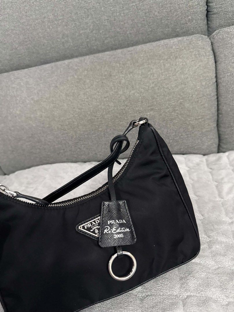 ORIGINAL Prada Re-Edition 2005 Nylon Shoulder Bag Black (Category: Luxury Bags & Wallets) located in Quezon City. Submitted by lovebyanne (Listing ID 1460707889, Image 3). Description: ORIGINAL PRADA 😍 - preloved and thrifted - 10/10 pristine condition - dm for more photos! - inclusions: only the bag - RFS: needs funds.