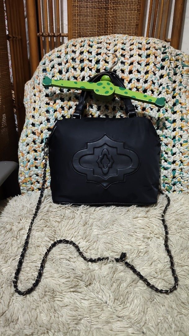 Oryany (Category: Cross-body Bags) located in Cebu City. Submitted by lumaynojes00490 (Listing ID 1460533695, Image 3). Description: - Stylish black handbag with elegant quilted front detail. - Versatile design: can be worn as a shoulder bag or crossbody. - Features comfortable top handles and a long, detachable chain strap. - Secure zipper closure to keep your belongings safe. - Made from durable and lightweight nylon material. - Ideal for every