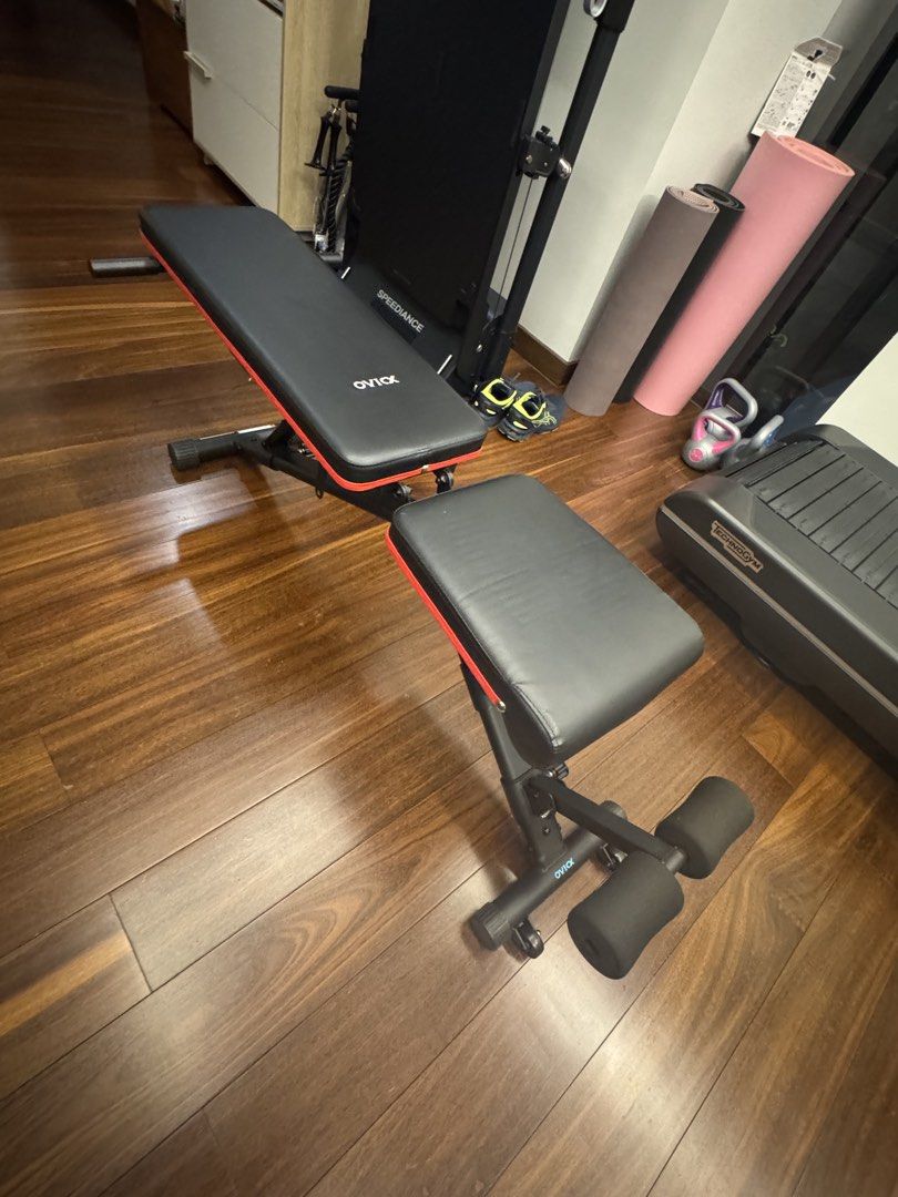OVIOX Adjustable Weight Training Bench (Category: Weights & Dumbbells) located in Makati City. Submitted by juxyluxy (Listing ID 1460657054, Image 1). Description: - Adjustable weight bench for versatile home workouts - Suitable for sit-ups, weightlifting, and building strength - Comfortable padded backrest and seat - Durable and sturdy metal frame with stylish red accents - Easily adjustable incline for different exercises.