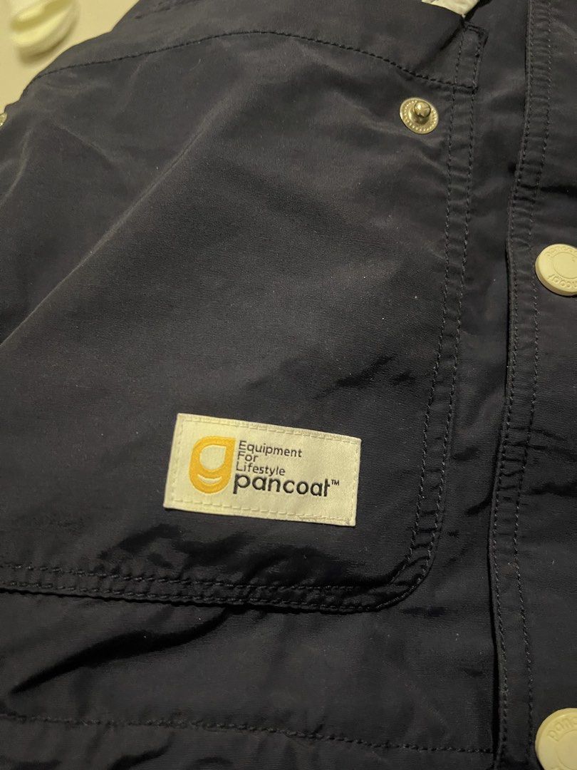 Pancoat Navy Blue Hooded Jacket (Category: Coats, Jackets and Outerwear) located in Lapu Lapu. Submitted by chelon.865 (Listing ID 1460701152, Image 3). Description: - Navy blue hooded jacket from Pancoat - Features iconic Pancoat character logo embroidered on the chest - Full button-up front - Two front pockets - White inner lining - Made in China - Ideal for casual wear.