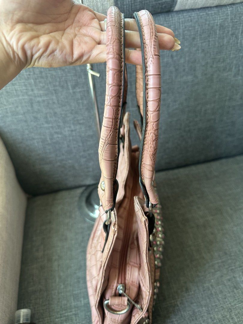 Pink Studded Croc-Embossed Shoulder Bag (Category: Shoulder Bags) located in Manila. Submitted by goldenhorse-dafc (Listing ID 1460565916, Image 2). Description: - Cute pink shoulder bag - Croc-embossed texture - Decorated with silver and pink studs - Zippered back pocket - Spacious main compartment with inner zip pocket - Sturdy top handles - Adds flair to any outfit.