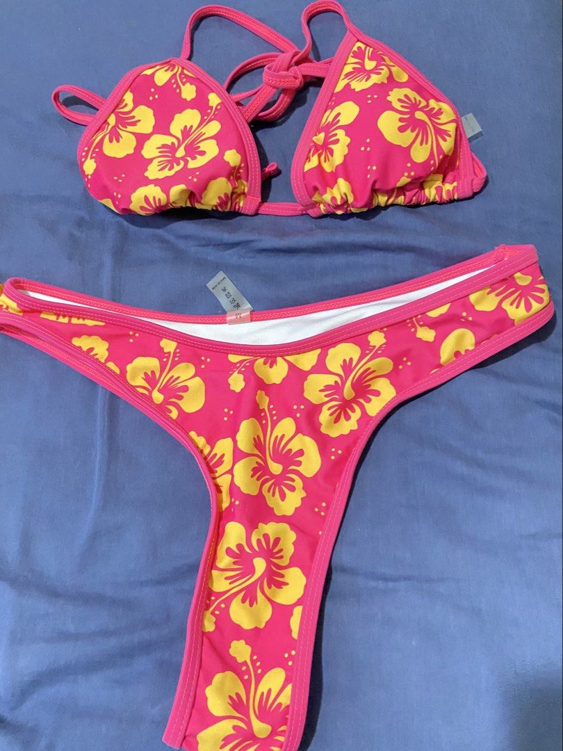 Pink Yellow Floral Bikini Set (Category: Bikinis & Swimsuits) located in Mandaluyong City. Submitted by coolmami (Listing ID 1460624510, Image 1). Description: - Adorable pink bikini with a vibrant yellow floral print. - Features a classic triangle top with adjustable tie closures for a perfect fit. - Comes with matching thong bottoms. - Ideal for your next beach or pool getaway. - Get ready for your vacation in style!.