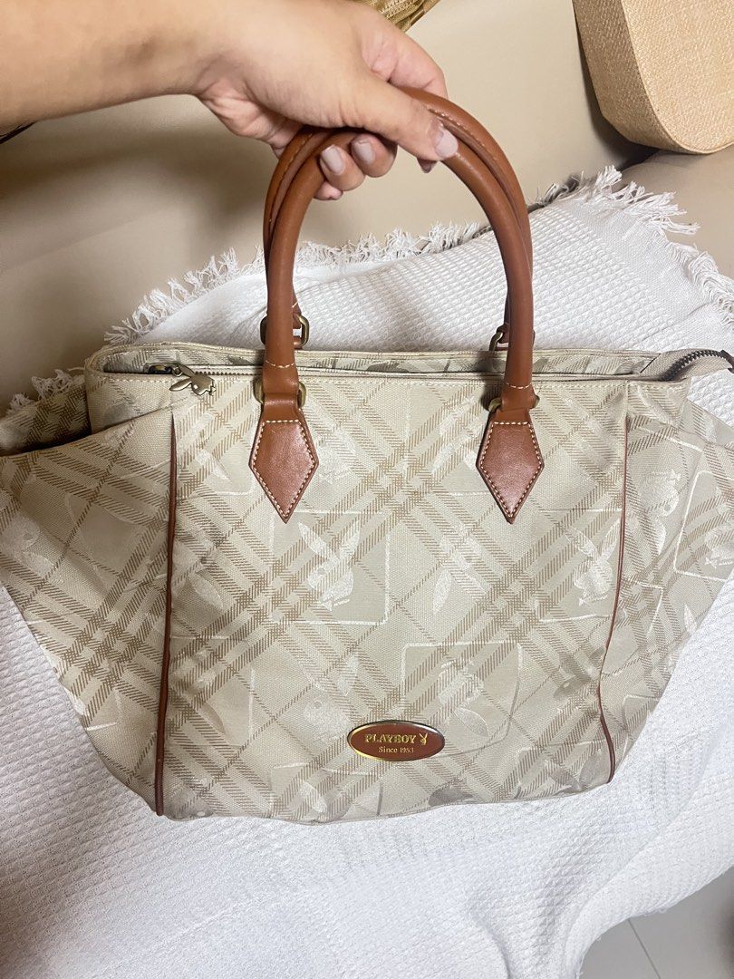 Playboy Monogram Tote Bag (Category: Luxury Bags & Wallets) located in Manila. Submitted by l0vecor3 (Listing ID 1460638858, Image 1). Description: - Classic Playboy tote bag - Beige and brown plaid monogram pattern - Leather trim and handles - Spacious interior - Interior zip pocket - Iconic Playboy bunny zipper pull - Ideal for everyday use.