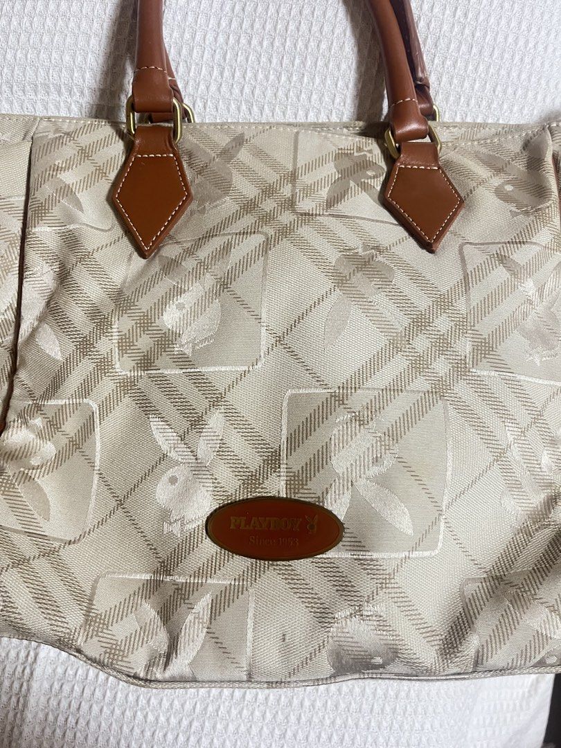 Playboy Monogram Tote Bag (Category: Luxury Bags & Wallets) located in Manila. Submitted by l0vecor3 (Listing ID 1460638858, Image 2). Description: - Classic Playboy tote bag - Beige and brown plaid monogram pattern - Leather trim and handles - Spacious interior - Interior zip pocket - Iconic Playboy bunny zipper pull - Ideal for everyday use.