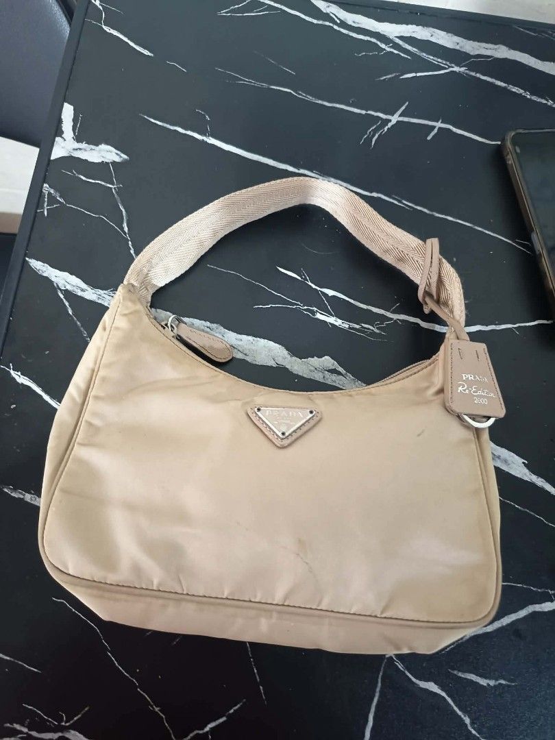 PRADA BEIGE TESSUTO NYLON RE-EDITION 2000 (Category: Luxury Bags & Wallets) located in Quezon City. Submitted by emily_1010 (Listing ID 1460597508, Image 1). Description: in good condition.