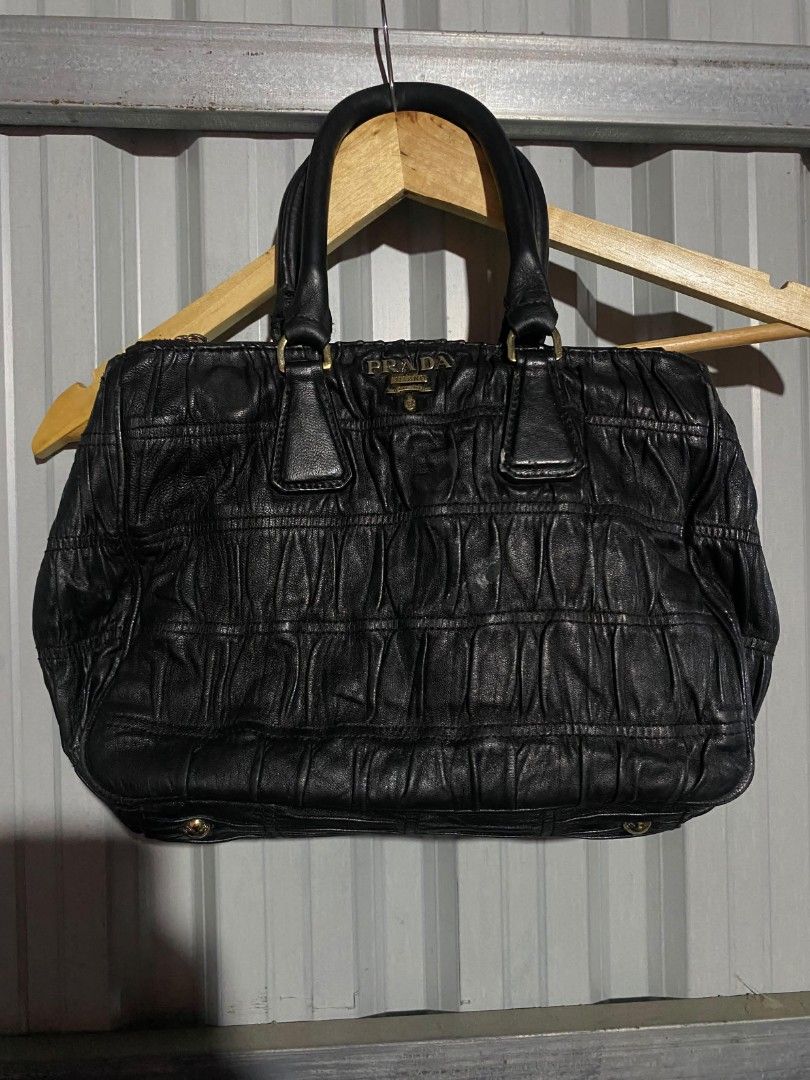 PRADA Black Gathered Leather Top Handle Bag (Category: Luxury Bags & Wallets) located in Bacolod City. Submitted by carlo1019 (Listing ID 1460670954, Image 1). Description: - Authentic PRADA handbag - Color: Black - Material: Leather with gathered texture - Hardware: Gold-tone - Features: Top handles, classic PRADA logo on front - Style: Chic and perfect for everyday use.