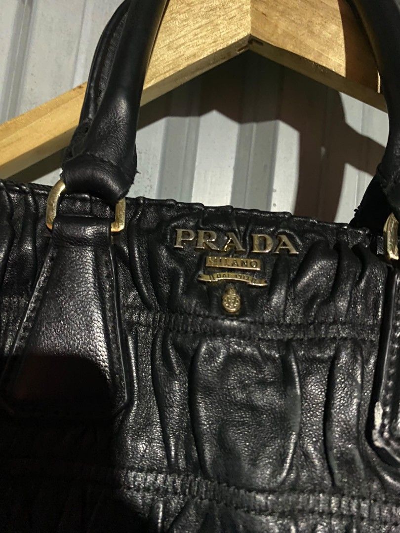 PRADA Black Gathered Leather Top Handle Bag (Category: Luxury Bags & Wallets) located in Bacolod City. Submitted by carlo1019 (Listing ID 1460670954, Image 2). Description: - Authentic PRADA handbag - Color: Black - Material: Leather with gathered texture - Hardware: Gold-tone - Features: Top handles, classic PRADA logo on front - Style: Chic and perfect for everyday use.