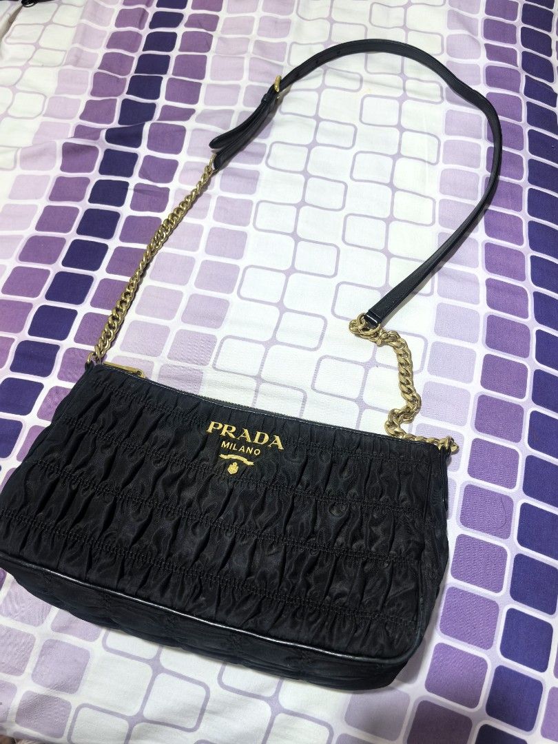 Prada Black Ruched Chain Shoulder Bag (Category: Luxury Bags & Wallets) located in Taguig. Submitted by undet27 (Listing ID 1460535936, Image 1). Description: - Authentic Black Prada Bag - Elegant Ruched Detailing - Luxurious Gold Chain Strap with Leather Accents - Iconic Prada Logo Emblem - Versatile Accessory for Any Occasion - Approx. Dimensions: [Insert Dimensions Here].