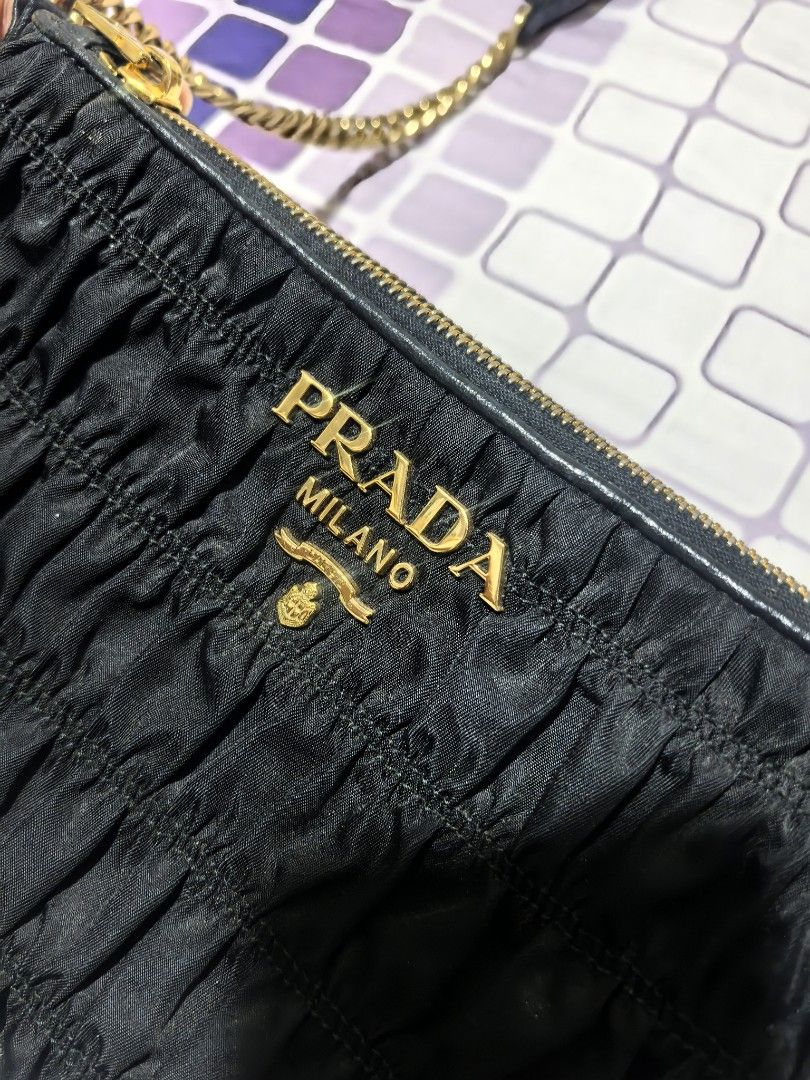 Prada Black Ruched Chain Shoulder Bag (Category: Luxury Bags & Wallets) located in Taguig. Submitted by undet27 (Listing ID 1460535936, Image 3). Description: - Authentic Black Prada Bag - Elegant Ruched Detailing - Luxurious Gold Chain Strap with Leather Accents - Iconic Prada Logo Emblem - Versatile Accessory for Any Occasion - Approx. Dimensions: [Insert Dimensions Here].