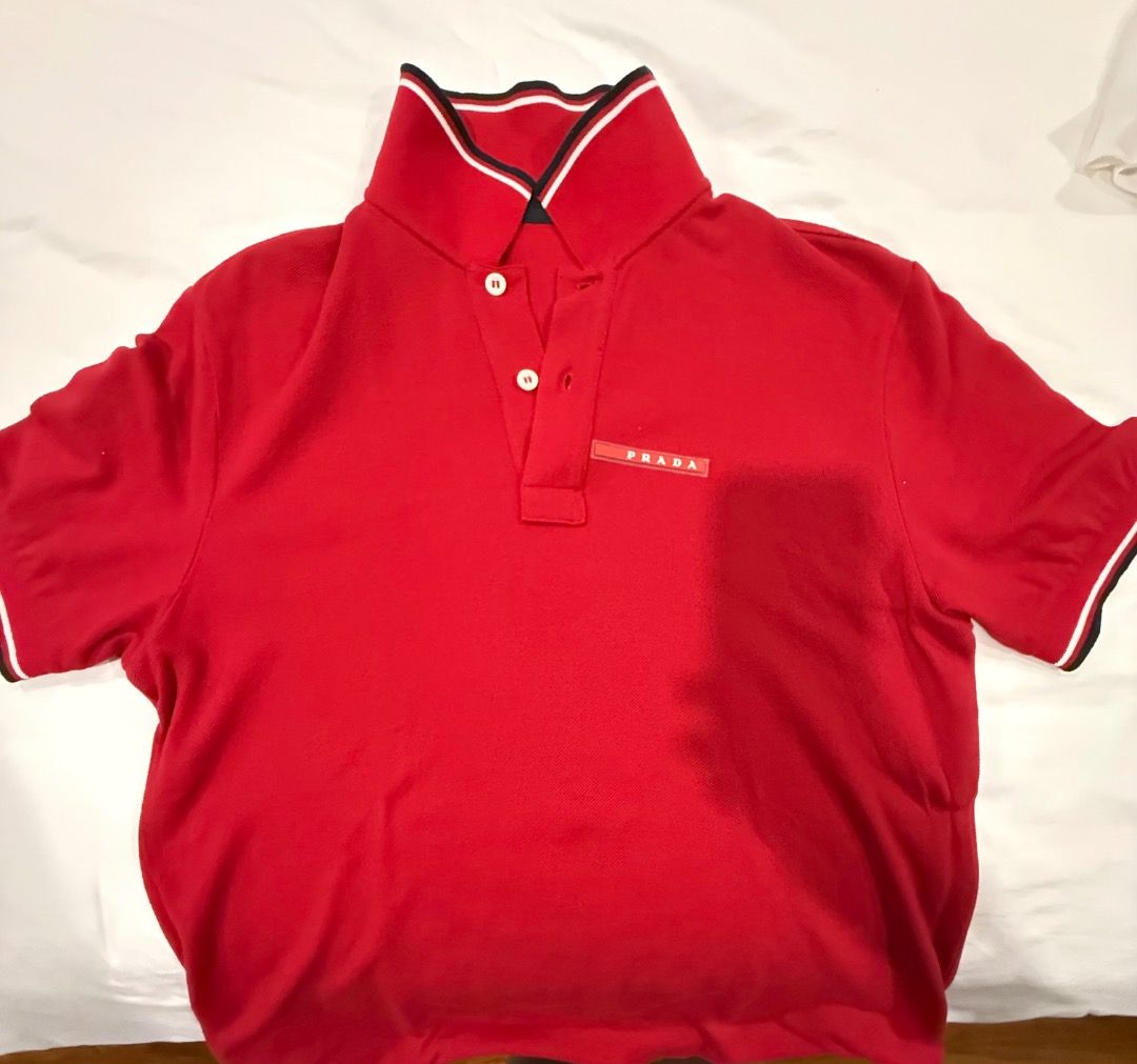 Prada Red Polo Shirt Size S (Category: Tshirts & Polo Shirts ) located in Quezon City. Submitted by ilabluxe (Listing ID 1460538665, Image 1). Description: - Authentic Prada Polo Shirt - Vibrant Bright Red Color - Classic Prada Logo Tag on Chest - Striped Detail on Collar - Short Sleeves with Striped Cuffs - Size: S - Ideal for Casual Wear 100% Authentic or Money Back Guarantee.