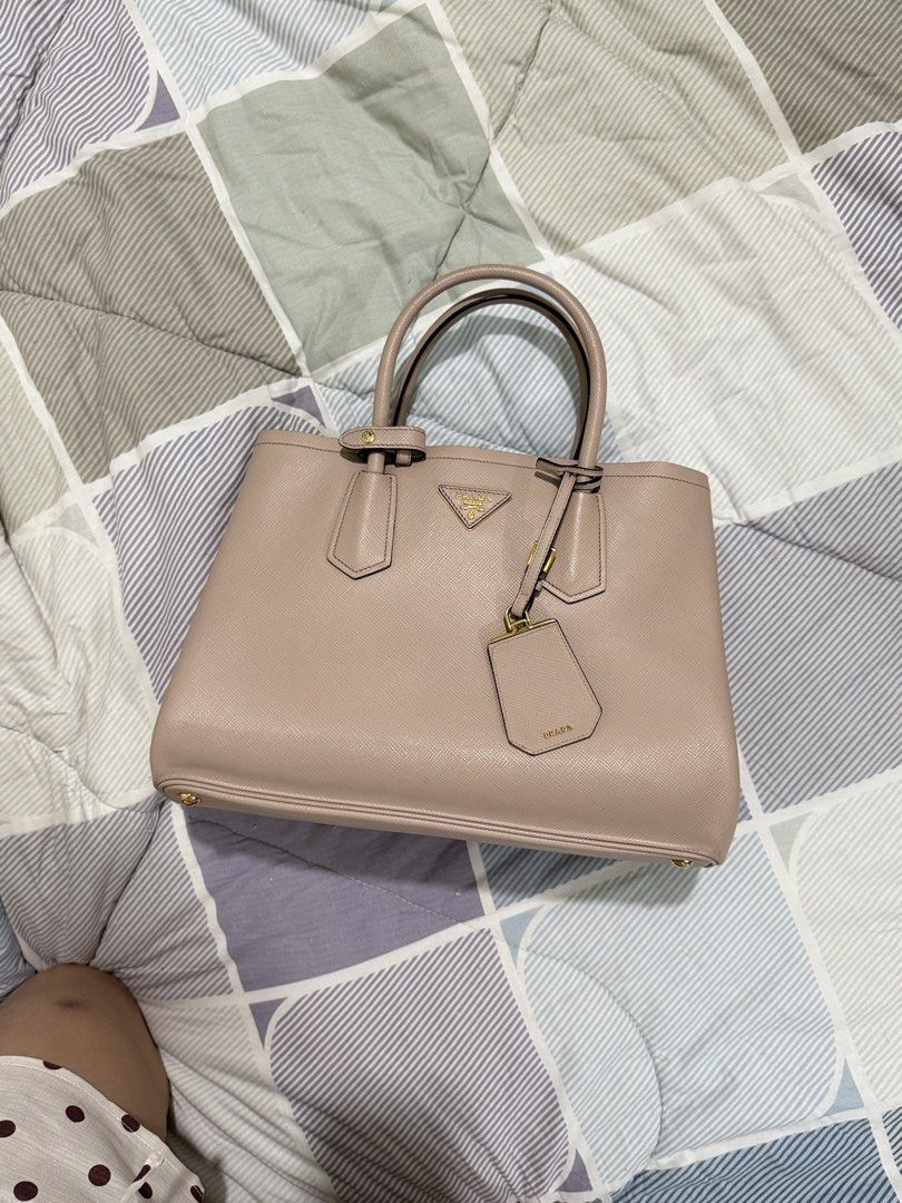 Prada Saffiano Cuir Small Double Bag (Category: Luxury Bags & Wallets) located in Manila. Submitted by lady_inde1988 (Listing ID 1460560879, Image 1). Description: - Authentic Prada Tote Bag - Made with genuine Saffiano leather - Features a detachable tag - Elegant gold hardware details - Very spacious interior - Ideal for everyday use or travel - Comes with authenticity card, dust bag, and enthruphy. .