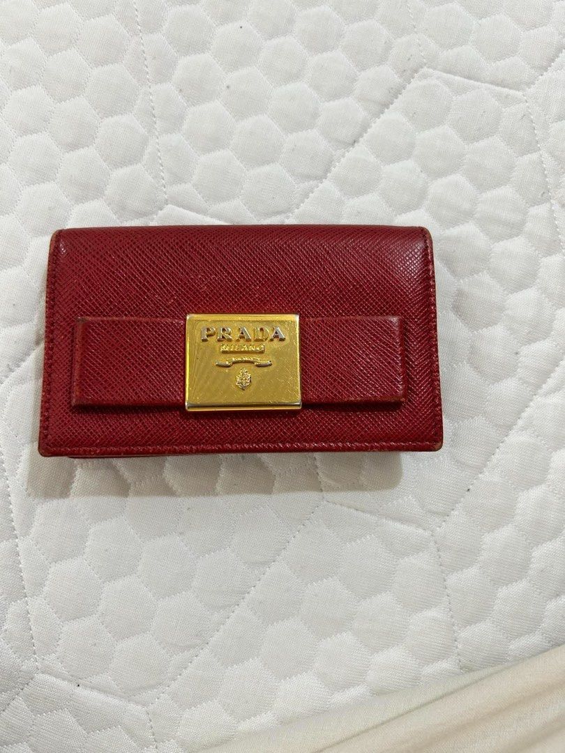 PRADA Saffiano Leather Bow Wallet authentic prada (Category: Wallets & Card holders) located in Manila. Submitted by truecrystal_vintage (Listing ID 1460694291, Image 1). Description: Preloved Prada wallet in classic red Saffiano leather - Gold-tone Prada Milano logo hardware - Signature bow design - Elegant and timeless piece - Spacious interior for cards, cash, and essentials Condition: Good preloved condition Minor signs of use from storage/we