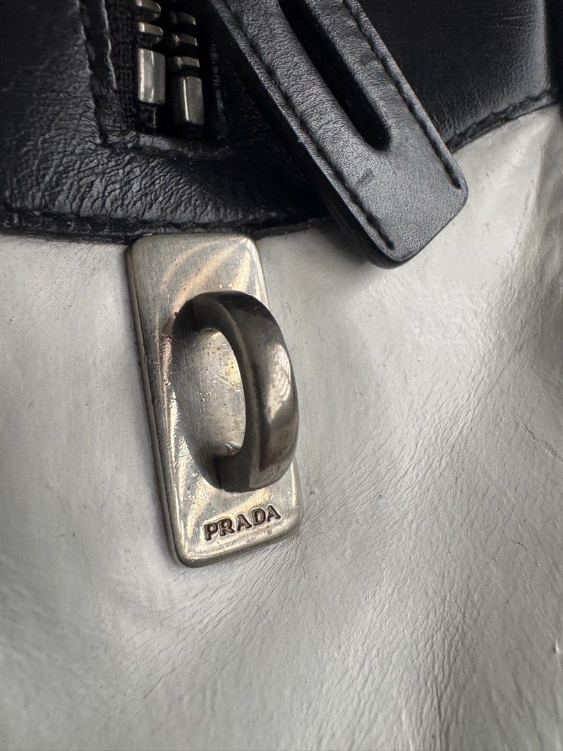 Prada Spring / Summer 2000 Bowler Bag (White Leather) (Category: Luxury Bags & Wallets) located in Angeles City. Submitted by thala.1204.68 (Listing ID 1460530981, Image 2). Description: - Aunthentic Classic Prada Bowler Bag with B101 Revue certificate/ 100% original - Black and white perforated leather - Top handles - Zip closure - Iconic Prada logo hardware - Stylish for any outfit - Great for daily use or special occasions.