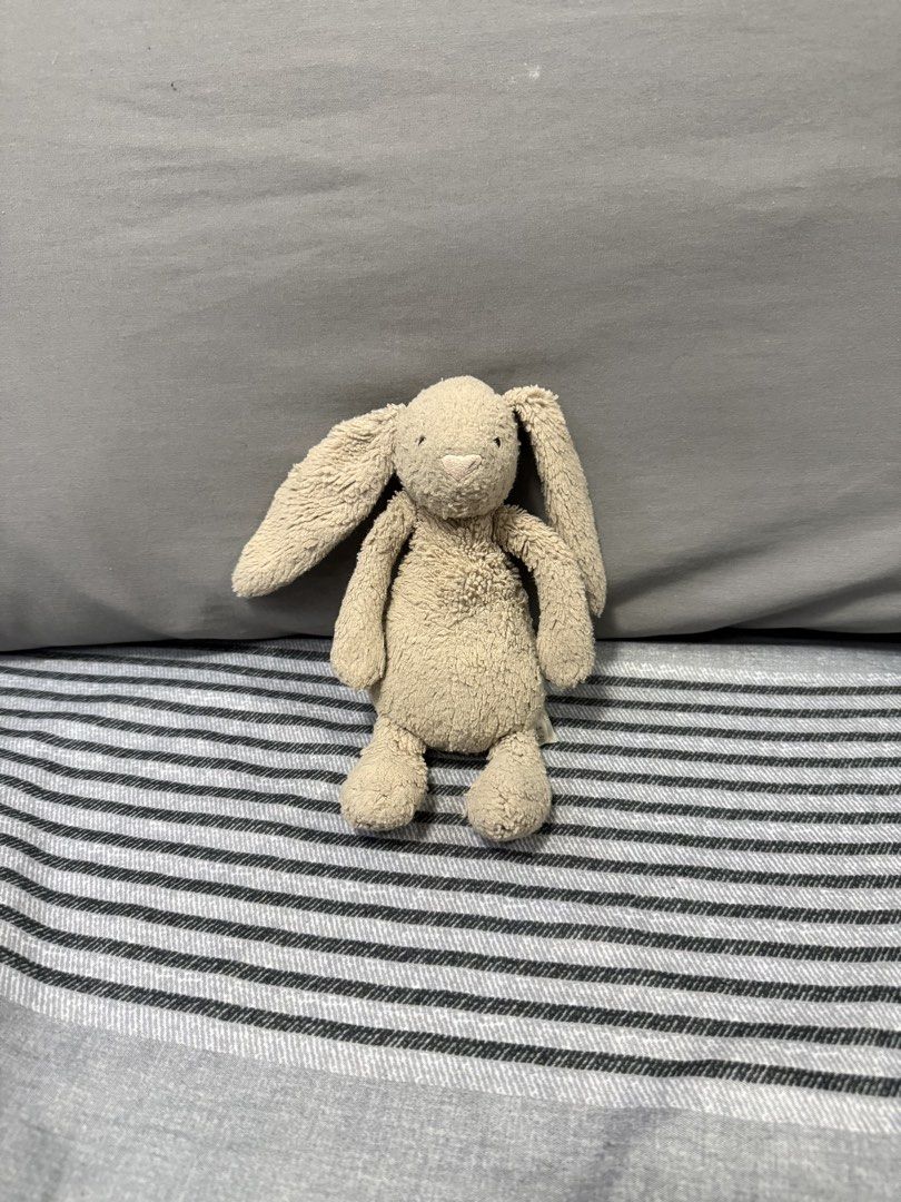 Preloved Jellycat Bunny Plush Toy (Category: Plushies & Soft Toys) located in Manila. Submitted by kunehoe (Listing ID 1460544203, Image 1). Description: - Super soft Jellycat bunny - Adorable beige color - Small size, perfect for carrying and cuddling - Great as a cute decor piece - Ideal gift for kids or Jellycat collectors - Clean and ready for its new home.
