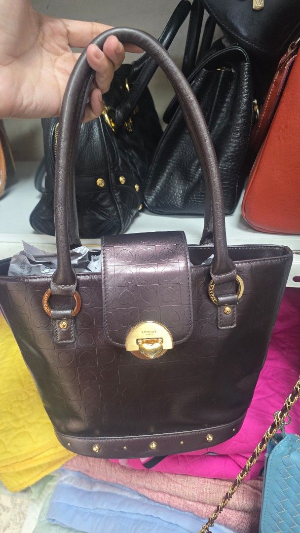 Preloved Lovecat Brown Monogram Shoulder Bag (Category: Luxury Bags & Wallets) located in Quezon City. Submitted by mbpreloved65 (Listing ID 1460540774, Image 1). Description: - Brown Lovecat shoulder bag - Signature all-over monogram pattern - Gold hardware details - Cute heart print lining - Interior zip pocket - Top handles for carrying - Ideal for everyday use.