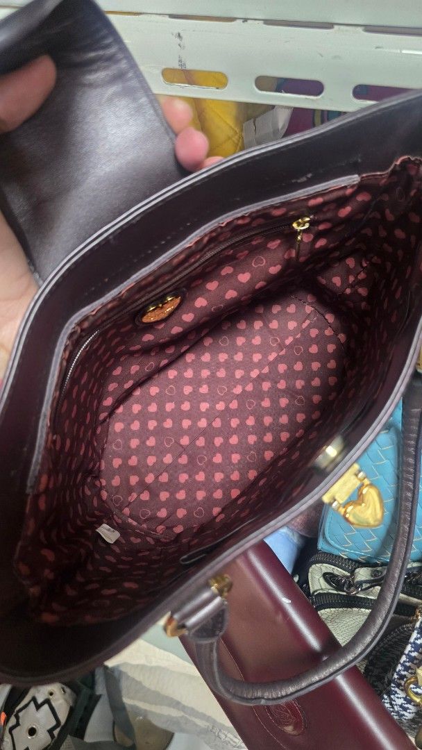 Preloved Lovecat Brown Monogram Shoulder Bag (Category: Luxury Bags & Wallets) located in Quezon City. Submitted by mbpreloved65 (Listing ID 1460540774, Image 3). Description: - Brown Lovecat shoulder bag - Signature all-over monogram pattern - Gold hardware details - Cute heart print lining - Interior zip pocket - Top handles for carrying - Ideal for everyday use.