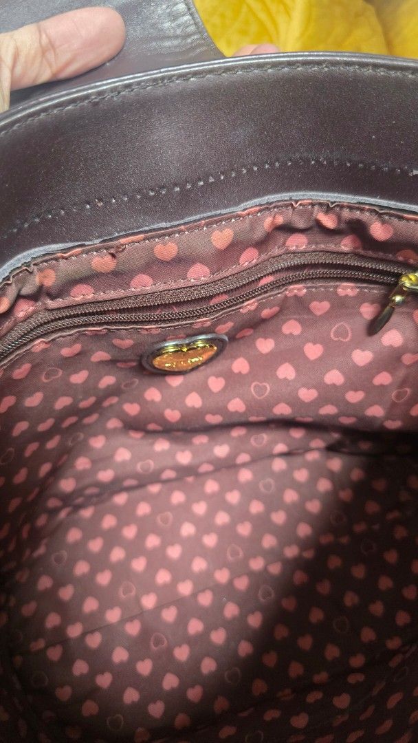 Preloved Lovecat Brown Monogram Shoulder Bag (Category: Luxury Bags & Wallets) located in Quezon City. Submitted by mbpreloved65 (Listing ID 1460540774, Image 2). Description: - Brown Lovecat shoulder bag - Signature all-over monogram pattern - Gold hardware details - Cute heart print lining - Interior zip pocket - Top handles for carrying - Ideal for everyday use.