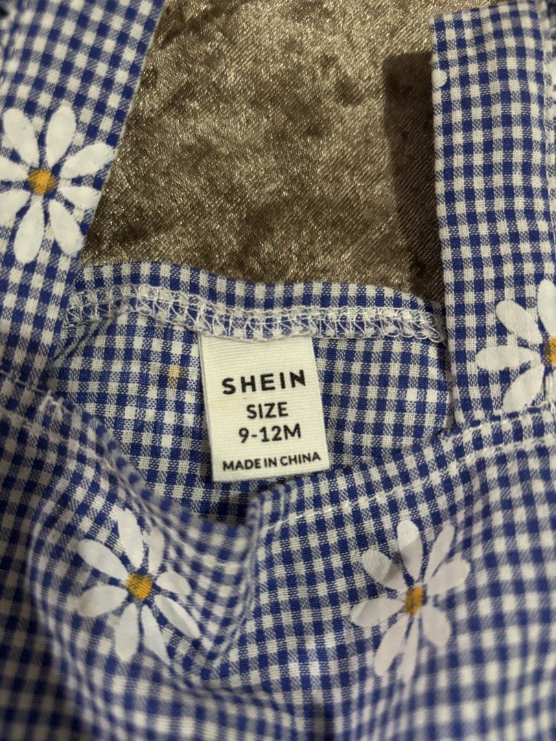 Preloved SHEIN Baby Top 9-12M (Category: Babies & Kids Fashion) located in Jagna. Submitted by aileendaguplo (Listing ID 1460652046, Image 2). Description: - Adorable blue gingham top with white daisy print. - Features sweet ruffle sleeves. - Elasticated waist for a comfortable fit. - Perfect for summer wear. - Brand: SHEIN - Size: 9-12 months.