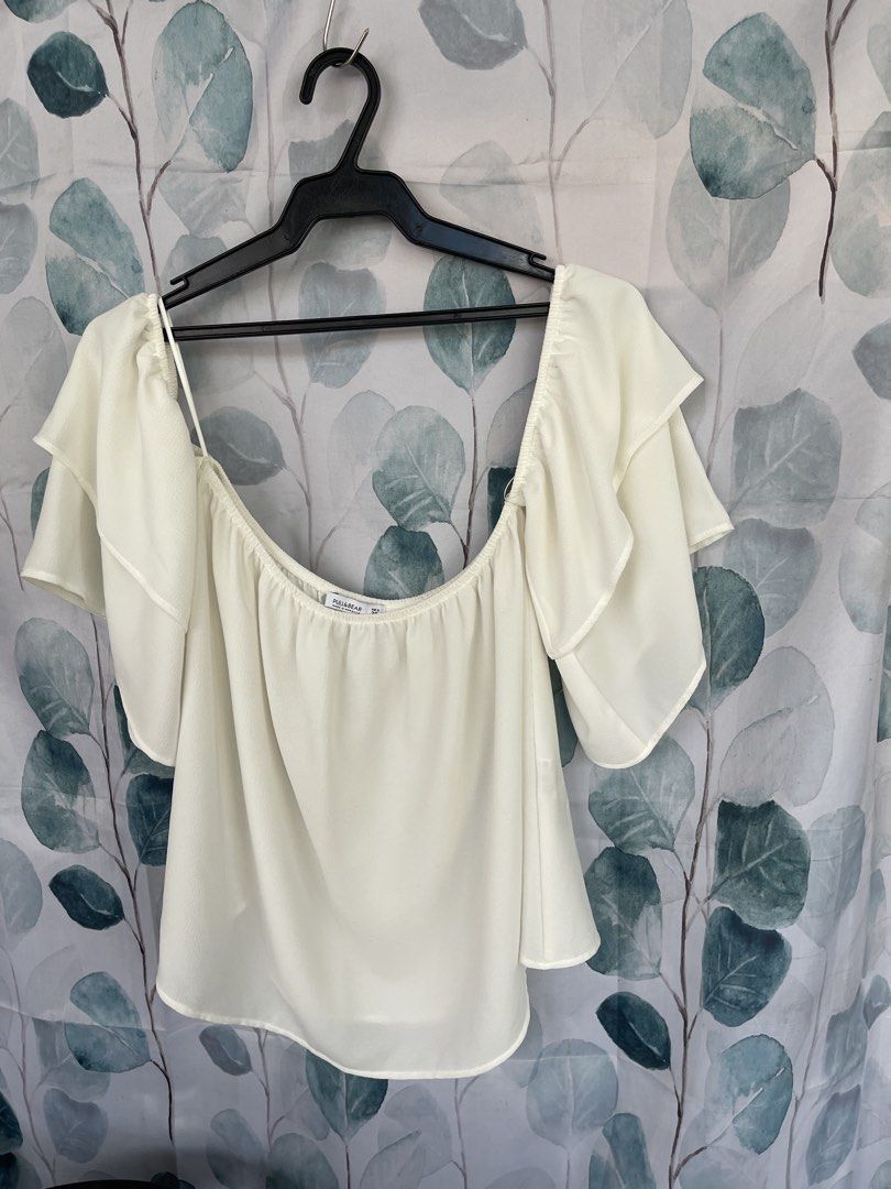 Pull & Bear Off Shoulder Ruffle Top (Category: Blouses) located in Mandaluyong City. Submitted by coolmeybab (Listing ID 1460536484, Image 1). Description: - White off-shoulder top - Brand: Pull & Bear - Features cute ruffle sleeves - Elasticated neckline for a comfortable fit - Versatile: pairs well with jeans or shorts Size: Mex 28 - Ideal for casual outings.