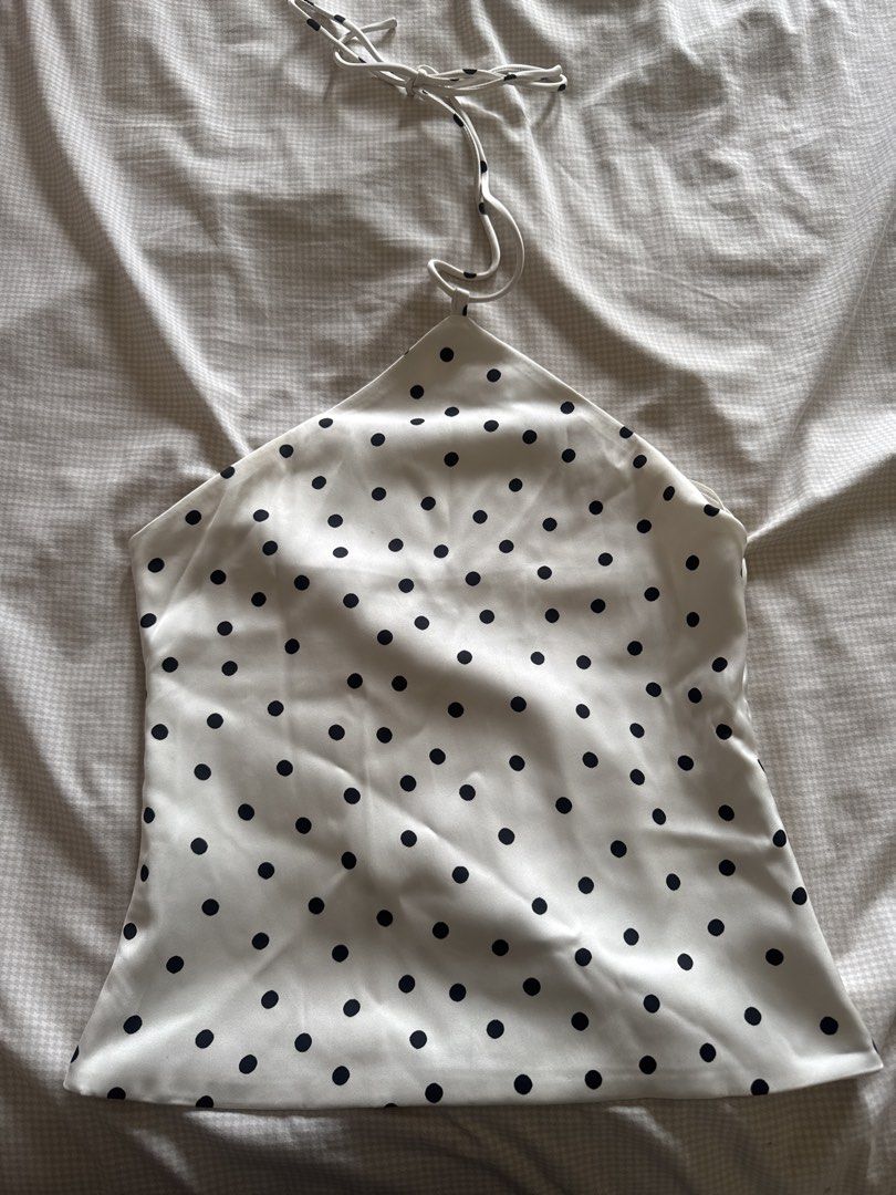 Pull&Bear White Polka Dot Halter Neck Top XS (Category: Sleeveless) located in Manila. Submitted by chicclosetco (Listing ID 1460545525, Image 1). Description: - White halter neck top - Black polka dot pattern - Silky, smooth material - Ties at the back of the neck - Size XS - Versatile: dress up or down.