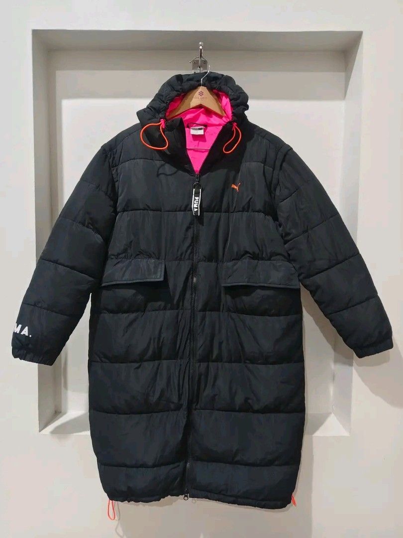 Puma Black Puffer Jacket with Pink Lining (Category: Coats, Jackets and Outerwear) located in Caloocan City. Submitted by clprelovedclothing (Listing ID 1460662197, Image 1). Description: - Long black puffer jacket from Puma - Features a vibrant pink lining - Eye-catching orange drawstring details - Two convenient front pockets - Puma logo prominently displayed on the chest - 'PUMA' text printed on the sleeve - Ideal for keeping warm and stylish.