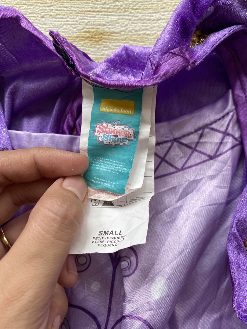 purple Shimmer costume (Category: Babies & Kids Fashion) located in Cebu City. Submitted by yjainani (Listing ID 1460527576, Image 3). Description: purple Shimmer costume from Shimmer and Shine featuring sparkly sheer sleeves and gold trim.